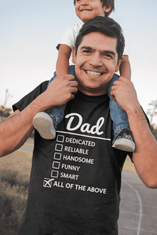 Dad humor T-shirt with checklist for qualities like dedicated, reliable, handsome, funny, smart, and all of the above.