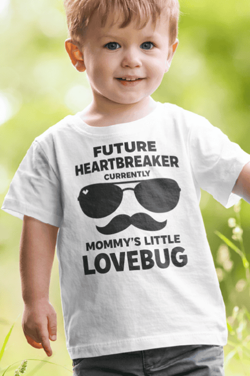 Cute boy wearing humorous "Future Heartbreaker" T-shirt with sunglasses and mustache design.