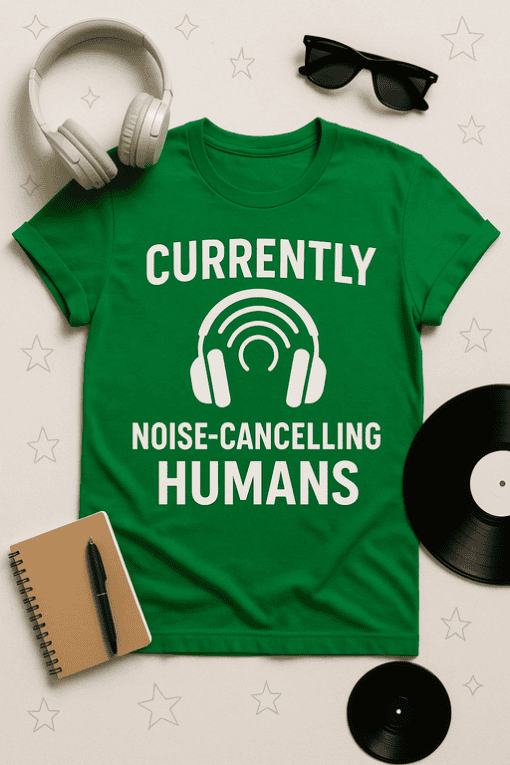 Headphones and vinyl records on a table with a green T-shirt with "currently noise-cancelling humans".