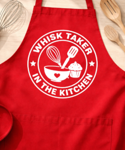 Funny apron with the slogan Whisk Taker in the Kitchen
